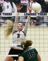 Lemoore's Shelby Saporetti (5) blocks a shot by El Diamante's Gillian Nutter in Tuesday volleyball action at Lemoore High School.
